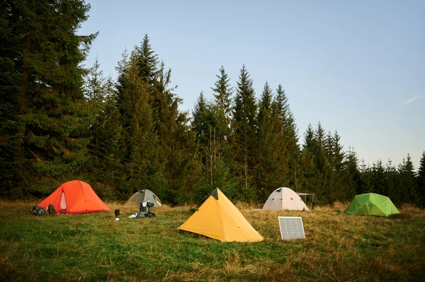 solar-panel-grassy-field-tents-background-600nw-2624454405